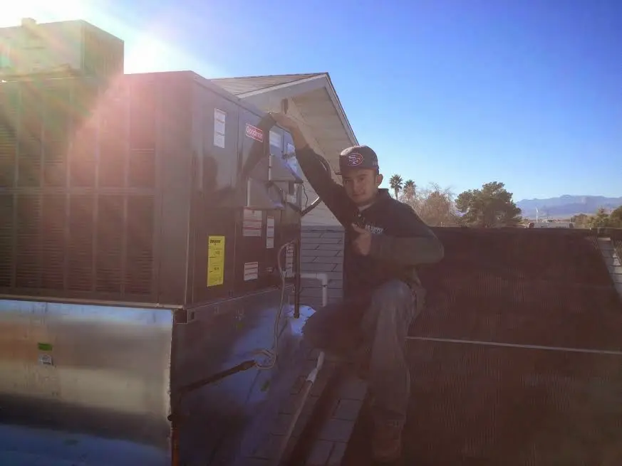 HVAC technician performing HVAC Inspection on a rooftop unit in South Abington